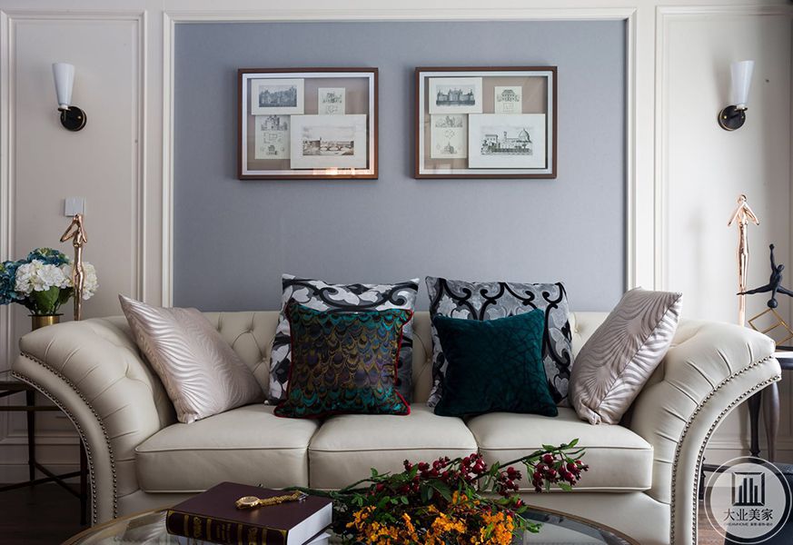 客厅沙发背景墙，背景墙分为3个部分，沙发主体背景颜色选用墙面以暖灰色，与沙发颜色区分开来，突出主体。2侧对称分布，颜色为白色。设置壁灯辅助照明。侧加以护墙板、石膏线条进行装饰，给人一种简约大气的感觉。