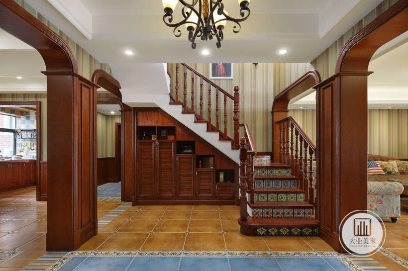 入户客厅整体色调为木色调。木饰面漆面门廊装饰，二层楼梯木台阶地板和扶手，楼梯下层空间定制储物柜增加储物空间。